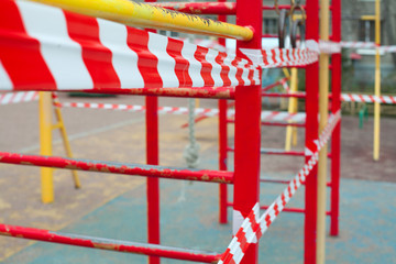 Empty closed playground with red warning tape