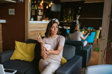 Obraz premium Pretty young caucasian woman makeup in a cafe