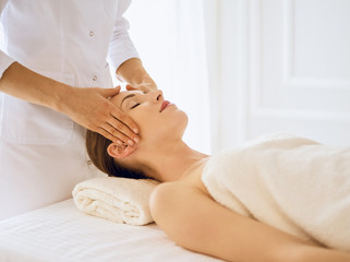 Beautiful woman enjoying facial massage with closed eyes