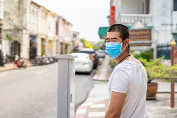 Asian man is wearing surgical mask during covid19 or corona virus spread