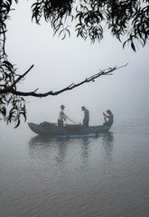 A fishing boat with fishermans in Sri Lanka fishing in Mist from Kalutara