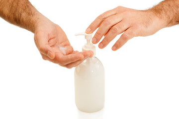 Closeup of two hands with a soap dispenser on white background