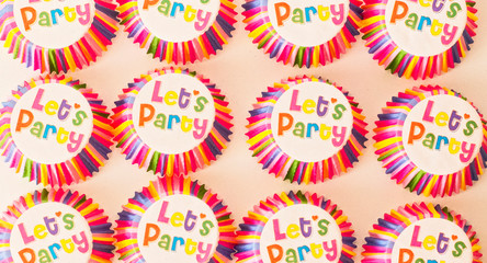 Let's celebrate the text on pink paper in the form of a cupcake. Invitation to a creative party.