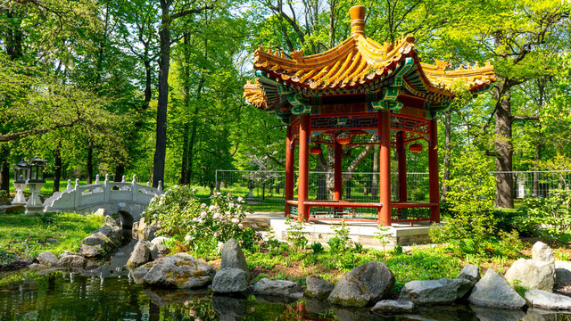 Warsaw, Poland, Europe - May 5, 2019: Days of Chinese culture in the Lazienki park. Chinese garden. Pagoda gazebo and its reflection near the pond in spring time.