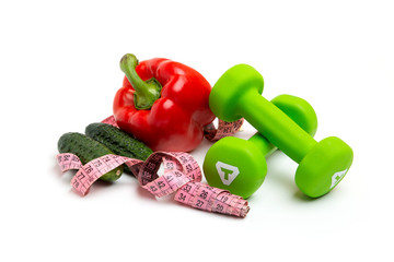 brigh red pepper with  dumbbells and Measuring tape, on a white background