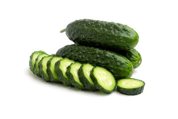 Bright green cucumbers sliced and whole isolated on a white background 
