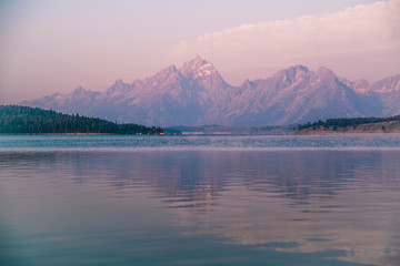 purple mountains and reflection of  grand tetons in wyoming