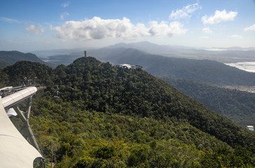 Panoramic view on mountains covered by trees and viewpoint from Sky Bridge in Langkawi Island. Vacation and holidays in Malaysia