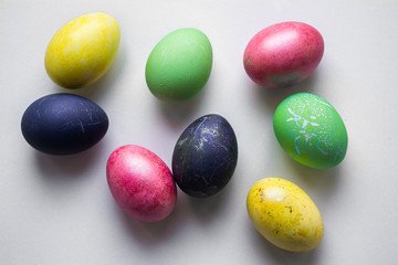 Fototapeta na wymiar Easter festive multi-colored mother-of-pearl chicken eggs lay on a white background