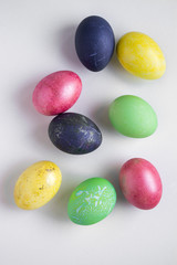 Easter festive multi-colored mother-of-pearl chicken eggs lay on a white background
