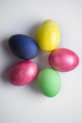 Easter festive multi-colored mother-of-pearl chicken eggs lay on a white background