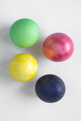 Easter eggs painted in different colors stand on holiday stands on a white background Russian