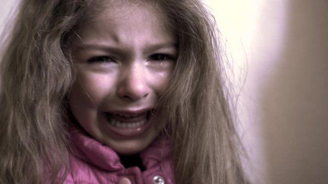 Little girl crying. Tears on face of child. Scared, sad and unhappy face of girl aged 5. Social awareness and children.