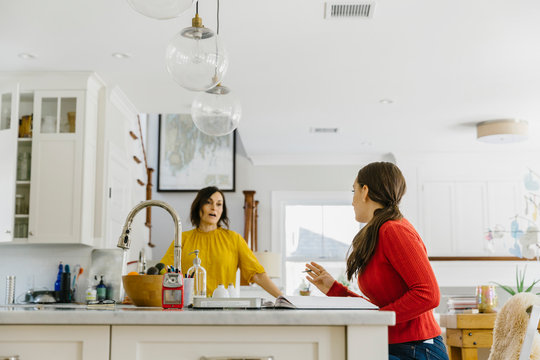 Mother Talking to Teenage Girl in Kitchen