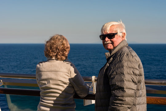 oldies standing outside on the deck of a cruise ship
