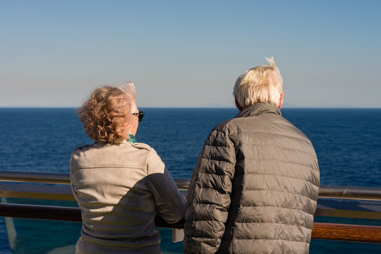 oldies standing outside on the deck of a cruise ship