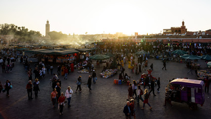 Obraz premium Marrakesh, Morocco - 04/05/2018: Tourists visiting Place Jemaa el Fna at sunset