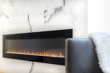 Modern fireplace in marble wall