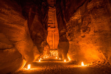 candle glow of petra at night in jordan - obrazy, fototapety, plakaty