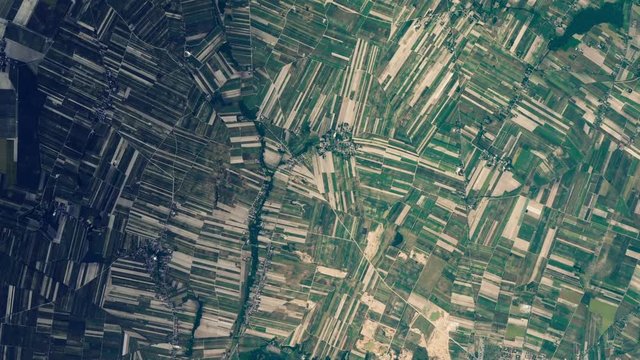 Cultivated land pattern satellite aerial scenic landscape sunrise animation of large agricultural field in Wart Poland. Images furnished by Nasa