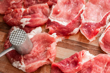 Pork chops. Raw chopped meat on a wooden plate.
