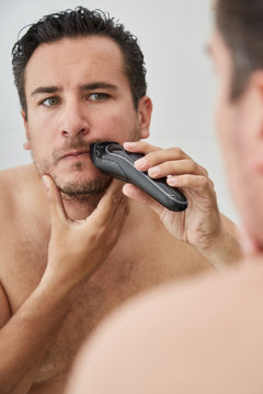 Man trimming beard