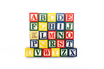 Alphabet characters written with wooden letters, education abstract background