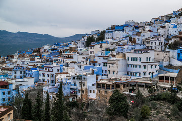 view of blue city with mountains in morocco 