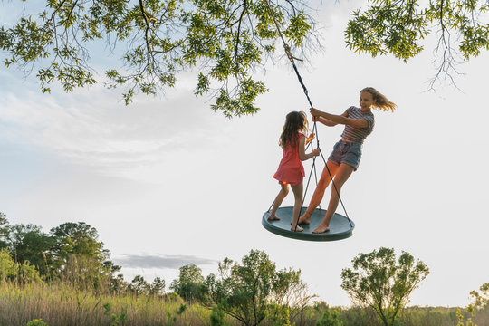 Kids Balancing on Tree Swing - Powered by Adobe