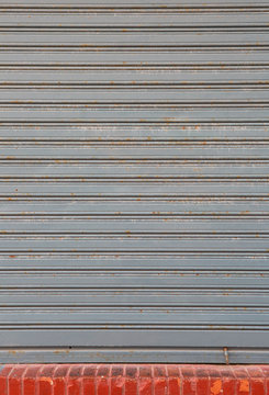 Silver security shutter with red step