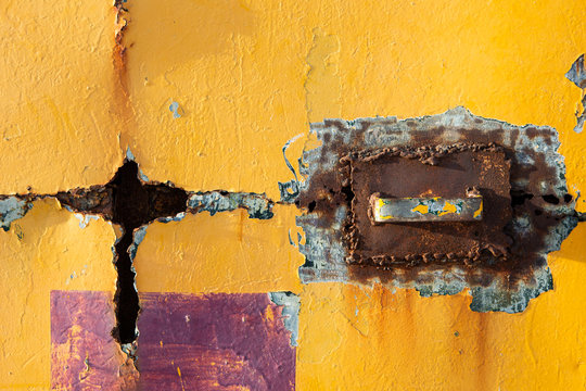 Detail of yellow door with rust
