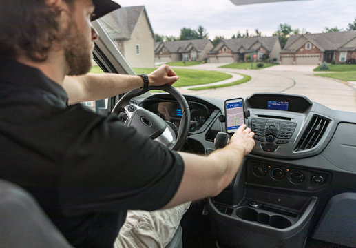 Shipping: Delivery Man Uses Cell Phone For Directions