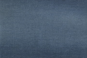 Fototapeta na wymiar Grunge texture of natural blue denim frayed fabric. Abstract monochrome background of beautiful classic denim.