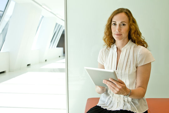 Portrait of mature businesswoman using digital tablet in office