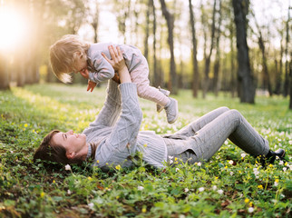 Mother plaing with child on meadow