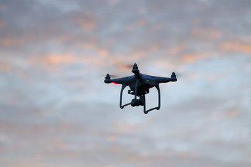 Drone quadcopter at sunset