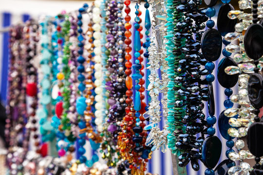 Various colorful beads in the market. Wallpaper background of a colorful necklace made of precious stones and colored beads.