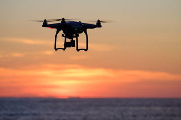 Fototapeta na wymiar Drone quadcopter at sunset