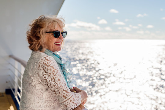 Side View Of Smiling Senior Woman On Cruise