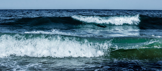 Summer. Sea. Sandy beach and fine sand. Small waves. Background.