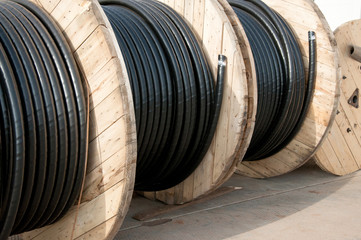 A bay of black Large diameter electric cable. Electric tools for construction works