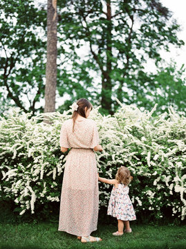 Mother and child near spirea bush