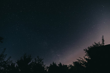 Night starry sky in the village in spring