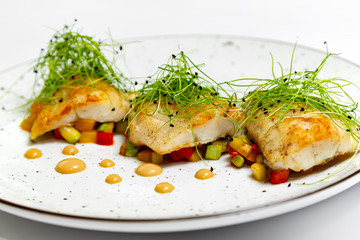 Fried fish on a plate on a white background