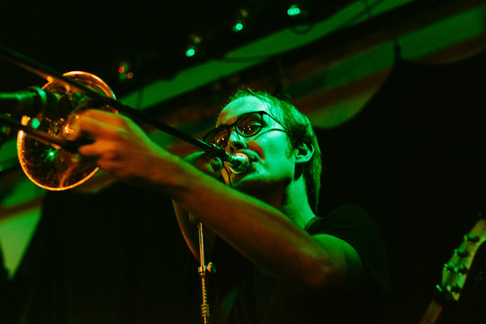 Portrait of a young male trombone musician on stage