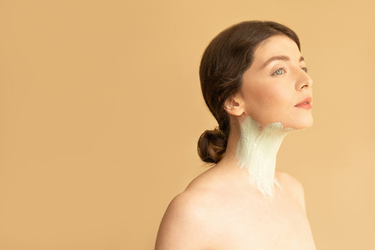 Woman Model Posing with Cosmetic Mask on her Neck