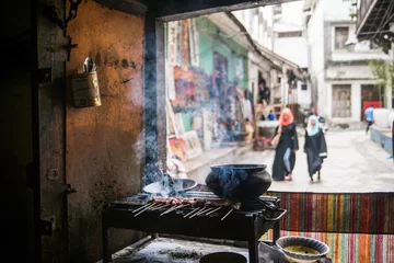 Rolgordijnen frying up some street food in downtown zanzibar tanzania © Zach