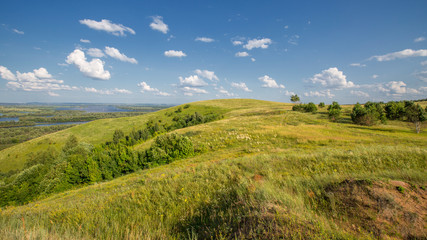 hills overgrown with grass and trees on the banks of the Vyatka River