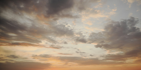Naklejka na ściany i meble Dramatic sunset sky. Cloudy sky as a background.