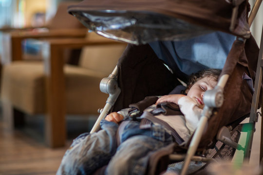 2 year old sleeping in a pushchair